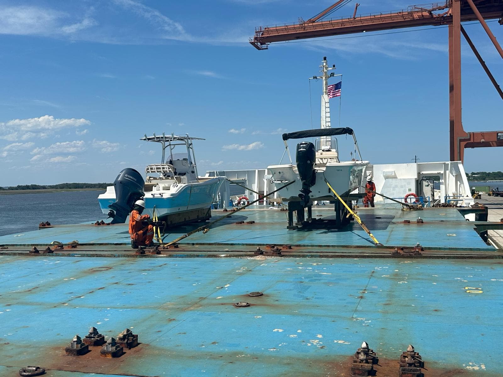 Newly imported boats lashed to the deck of a cargo ship bound for Bermuda, mid-import
