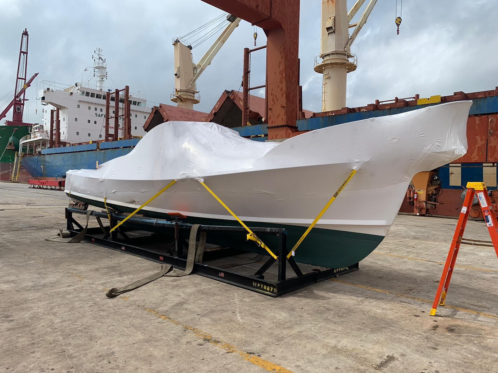 Shrink-wrapped sport fisher at the Bermuda port mid-delivery
