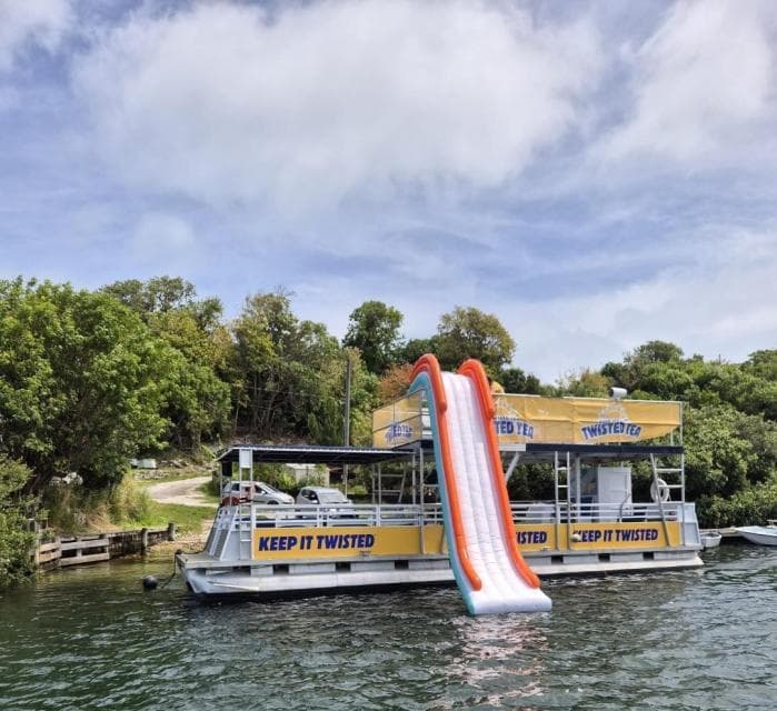 The Pontune Paradise at the dock with its inflatable water slide deployed