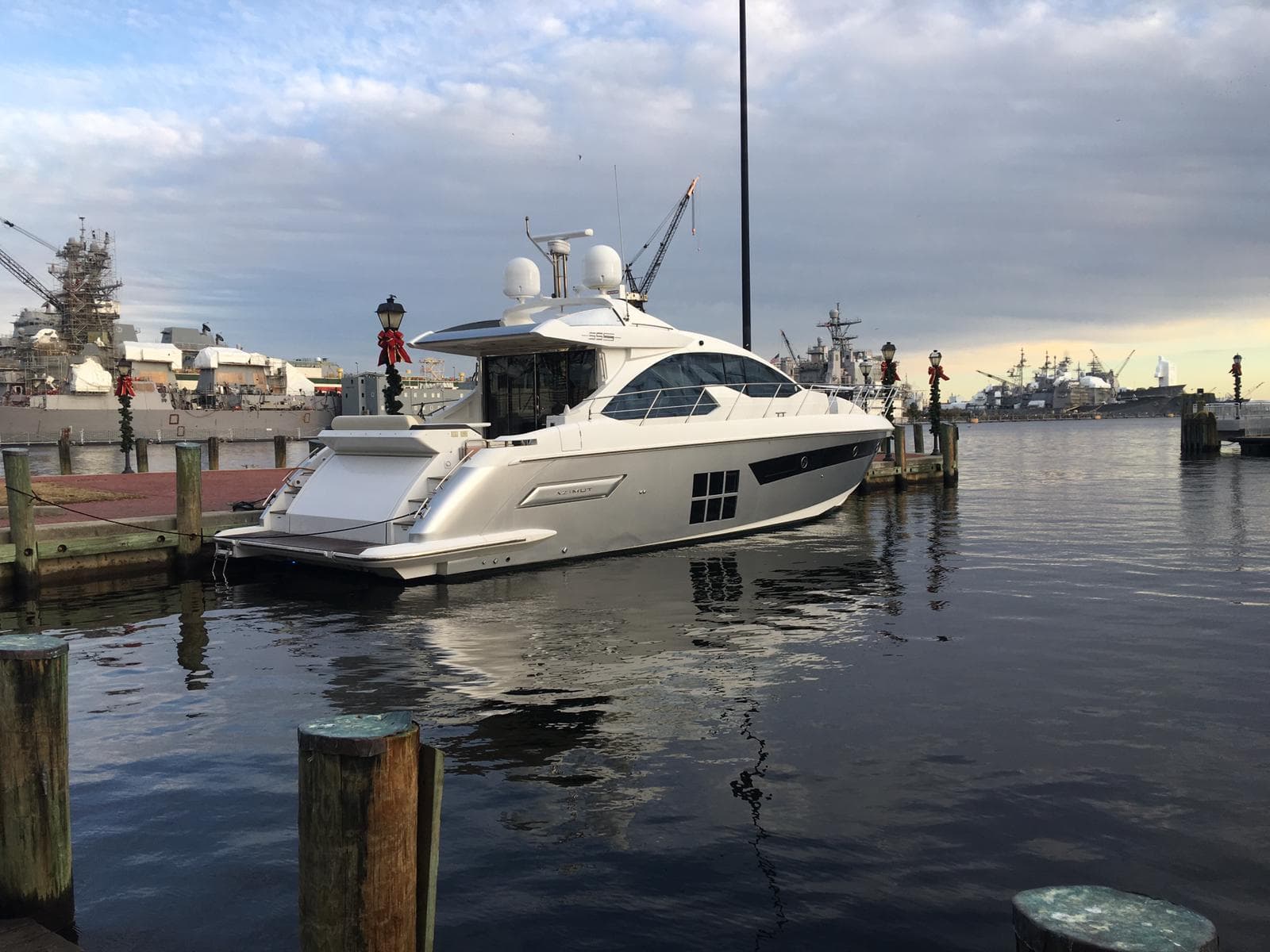 A motor yacht dockside in Bermuda at golden hour, the kind Sean places for buyers